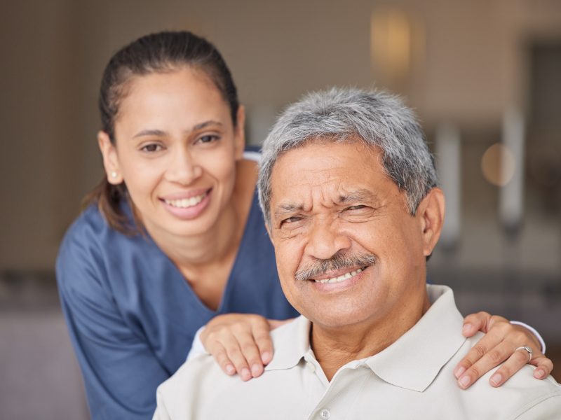 portrait-of-elderly-man-with-a-nurse-bonding-during-a-checkup-at-assisted-living-homecare-smile-.jpg